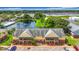 Exterior aerial view of multi-Gathering homes with pond views and fountain feature and lush landscaping at 200 Country Club Dr # 202, Largo, FL 33771