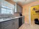 Bright kitchen featuring a large window, gray cabinets, and stainless steel sink at 200 Country Club Dr # 202, Largo, FL 33771