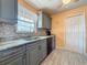 Modern kitchen featuring grey cabinets, stainless appliances, and mosaic backsplash at 200 Country Club Dr # 202, Largo, FL 33771