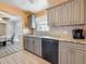 Updated kitchen with gray cabinets, granite countertops, and stainless steel appliances at 200 Country Club Dr # 202, Largo, FL 33771