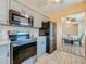 Modern kitchen featuring stainless steel appliances and gray cabinets at 200 Country Club Dr # 202, Largo, FL 33771