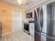 Updated kitchen featuring stainless steel appliances, gray cabinets, and tile backsplash at 200 Country Club Dr # 202, Largo, FL 33771