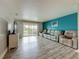 Comfortable living room featuring a large sectional sofa and sliding glass doors to a balcony at 200 Country Club Dr # 202, Largo, FL 33771
