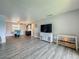 Spacious living room with modern decor, including a TV and shelving units at 200 Country Club Dr # 202, Largo, FL 33771