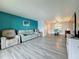 Living room with sectional sofa, TV, and open access to the dining area with table and chairs at 200 Country Club Dr # 202, Largo, FL 33771