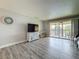 Bright and airy living room leading to a balcony with waterfront views, complete with TV and storage at 200 Country Club Dr # 202, Largo, FL 33771