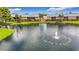Exterior view of apartments near the pond with a fountain in the center and well manicured landscape at 200 Country Club Dr # 202, Largo, FL 33771