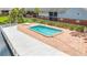Aerial view of community swimming pool with a white dock and a serene setting with greenery and shade at 200 Country Club Dr # 202, Largo, FL 33771