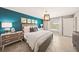 Bedroom featuring a teal accent wall, king bed, and a view of the pool at 20214 Banner Ave, Port Charlotte, FL 33952