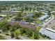 Scenic aerial view of a lakeside community with mature trees, parking, pools, and recreational areas at 214 Caryl Way, Oldsmar, FL 34677