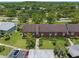 Aerial view of well-maintained condominium buildings with lush greenery, parking, and mature trees at 214 Caryl Way, Oldsmar, FL 34677