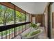 Cozy outdoor balcony with comfortable seating overlooking greenery and open recreational spaces at 214 Caryl Way, Oldsmar, FL 34677