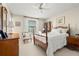 Well-lit bedroom with a four-poster bed, fan, and neutral decor at 214 Caryl Way, Oldsmar, FL 34677