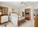 Bright bedroom with wooden furniture, ceiling fan, and a view of the closet at 214 Caryl Way, Oldsmar, FL 34677