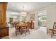 Bright dining room with chandelier, table, seating for four, and a large decorative mirror at 214 Caryl Way, Oldsmar, FL 34677