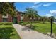View of the front of this red brick building with manicured front lawn and landscaping at 214 Caryl Way, Oldsmar, FL 34677