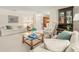Bright living room featuring neutral walls, comfortable furniture, and a glass-top coffee table at 214 Caryl Way, Oldsmar, FL 34677