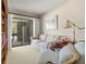 Cozy sitting room featuring a plaid couch, bookshelves, and a sliding glass door at 214 Caryl Way, Oldsmar, FL 34677