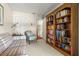 Comfortable sitting room with a large bookshelf and a view into the hallway at 214 Caryl Way, Oldsmar, FL 34677