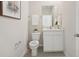 Clean powder room featuring a vanity, mirror, and neutral decor at 2328 Stratten Dr, Zephyrhills, FL 33541