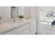 Bathroom featuring double sinks with white cabinets and sleek chrome fixtures at 2328 Stratten Dr, Zephyrhills, FL 33541