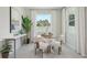 Cozy dining area featuring large windows, a modern table setting, and tasteful decor at 2238 Stratten Dr, Zephyrhills, FL 33541