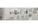 Open-concept kitchen featuring white cabinetry and a breakfast bar at 2328 Stratten Dr, Zephyrhills, FL 33541