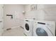 Functional laundry room includes a washer, dryer, sink, storage and coat rack, perfect for chores at 2328 Stratten Dr, Zephyrhills, FL 33541