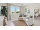 Bright sitting area with large windows, elegant curtains, and comfortable furniture at 2328 Stratten Dr, Zephyrhills, FL 33541