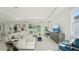 Inviting living room featuring a large sectional sofa, shiplap wall, and natural light at 2328 Stratten Dr, Zephyrhills, FL 33541