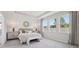 Serene main bedroom featuring tray ceilings, paneling, and ample natural light at 2328 Stratten Dr, Zephyrhills, FL 33541