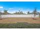 Spacious backyard with a white privacy fence and grass at 22445 Quasar Blvd, Port Charlotte, FL 33952