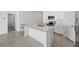 Modern kitchen with a central island, white cabinets, and stainless steel appliances at 22445 Quasar Blvd, Port Charlotte, FL 33952
