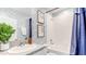 Stylish bathroom featuring decorative wallpaper, granite countertop, white tile, and framed artwork at 2328 Stratten Dr, Zephyrhills, FL 33541
