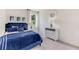 Serene bedroom with a blue upholstered bed frame, neutral walls, and natural light, creating a relaxing atmosphere at 2328 Stratten Dr, Zephyrhills, FL 33541