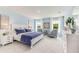 Serene blue bedroom with ample natural light, white furniture, and stylish decor at 2328 Stratten Dr, Zephyrhills, FL 33541