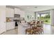 Modern kitchen featuring white cabinets, stainless steel appliances, and a granite island with bar stool seating at 2328 Stratten Dr, Zephyrhills, FL 33541