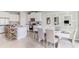 Open concept kitchen and dining area featuring white cabinets and granite countertops with dining table at 2328 Stratten Dr, Zephyrhills, FL 33541