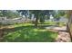 Expansive backyard featuring a concrete patio, mature shade trees, and a privacy fence at 2503 Elm St, Seffner, FL 33584