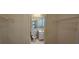 Walk-in closet reveals a bathroom with standard features and lighting at 2503 Elm St, Seffner, FL 33584
