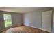 Bright bedroom features wood-look floors and natural light from a large window at 2503 Elm St, Seffner, FL 33584
