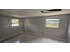 This bedroom features two windows, tile flooring, and gray walls at 2503 Elm St, Seffner, FL 33584