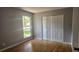 Bedroom featuring wood flooring, a window, and a closet with sliding doors at 2503 Elm St, Seffner, FL 33584