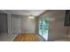 Dining area with wood flooring and sliding glass door to the backyard at 2503 Elm St, Seffner, FL 33584