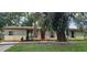 Charming single-story home with a fenced yard and lush greenery at 2503 Elm St, Seffner, FL 33584