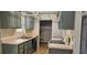 Functional kitchen with gray cabinets, light countertops, and laminate flooring at 2503 Elm St, Seffner, FL 33584