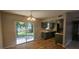 Open kitchen leading to a dining area and a sliding glass door to the backyard at 2503 Elm St, Seffner, FL 33584