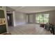 Bright living room with tile floors, large window, and neutral paint at 2503 Elm St, Seffner, FL 33584