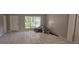 Bright living room featuring tile flooring, a large window, and a white front door at 2503 Elm St, Seffner, FL 33584