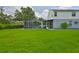 Lush backyard featuring a screened-in pool and expansive green space, perfect for outdoor activities at 3633 Springville Dr, Valrico, FL 33596